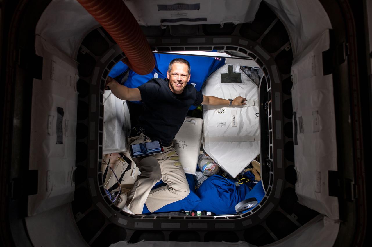 iss067e122806 (June 9, 2022) --- NASA astronaut and Expedition 67 Flight Engineer Bob Hines is pictured during cargo operations and inventory tasks inside the Cygnus space freighter from Northrop Grumman.