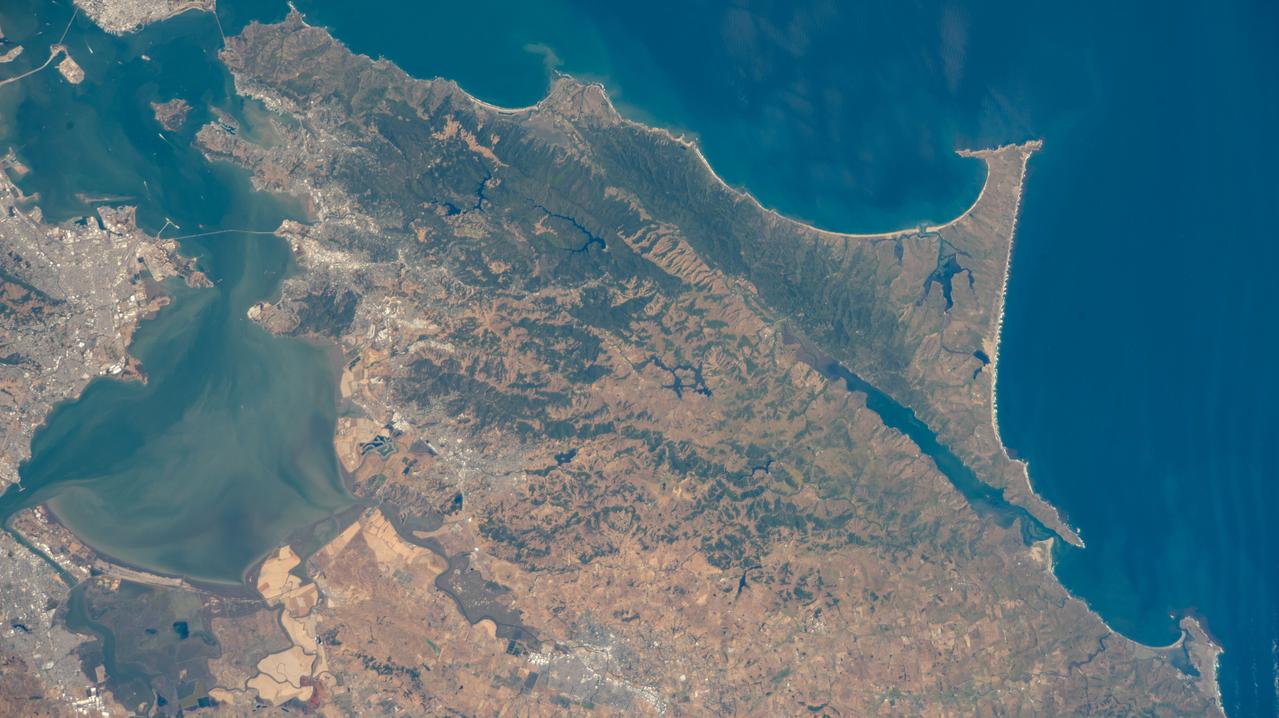iss067e123245 (June 10, 2022) --- Portions of the cities of Oakland and San Francisco (upper left) on San Francisco Bay and San Pablo Bay in California are pictured from the International Space Station as it orbited 263 miles above Monterey Bay in the Golden State.