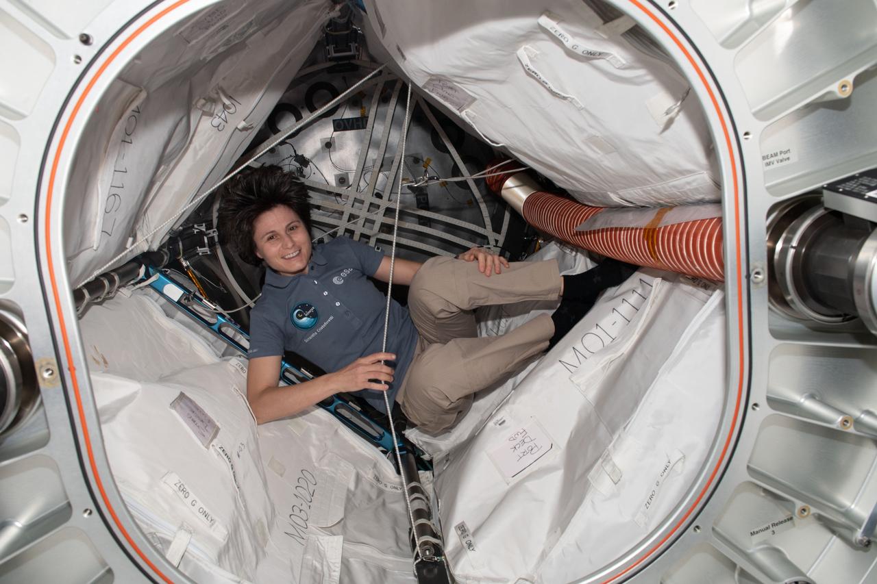 iss067e123266 (June 10, 2022) --- Expedition 67 Flight Engineer and ESA (European Space Agency) astronaut Samantha Cristoforetti is pictured inside the Bigelow Expandable Activity Module (BEAM) swapping batteries inside its sensor systems.
