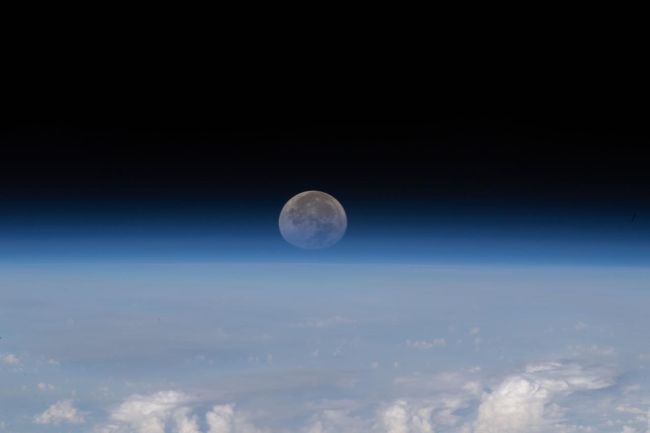 iss067e139457 (June 15, 2022) --- As the Moon sets below Earth's horizon the atmosphere refracts, or bends, its light making it appear flatter in this photograph taken from the International Space Station as it orbited 261 miles above the Himalayas near Kathmandu, the capital of Nepal.