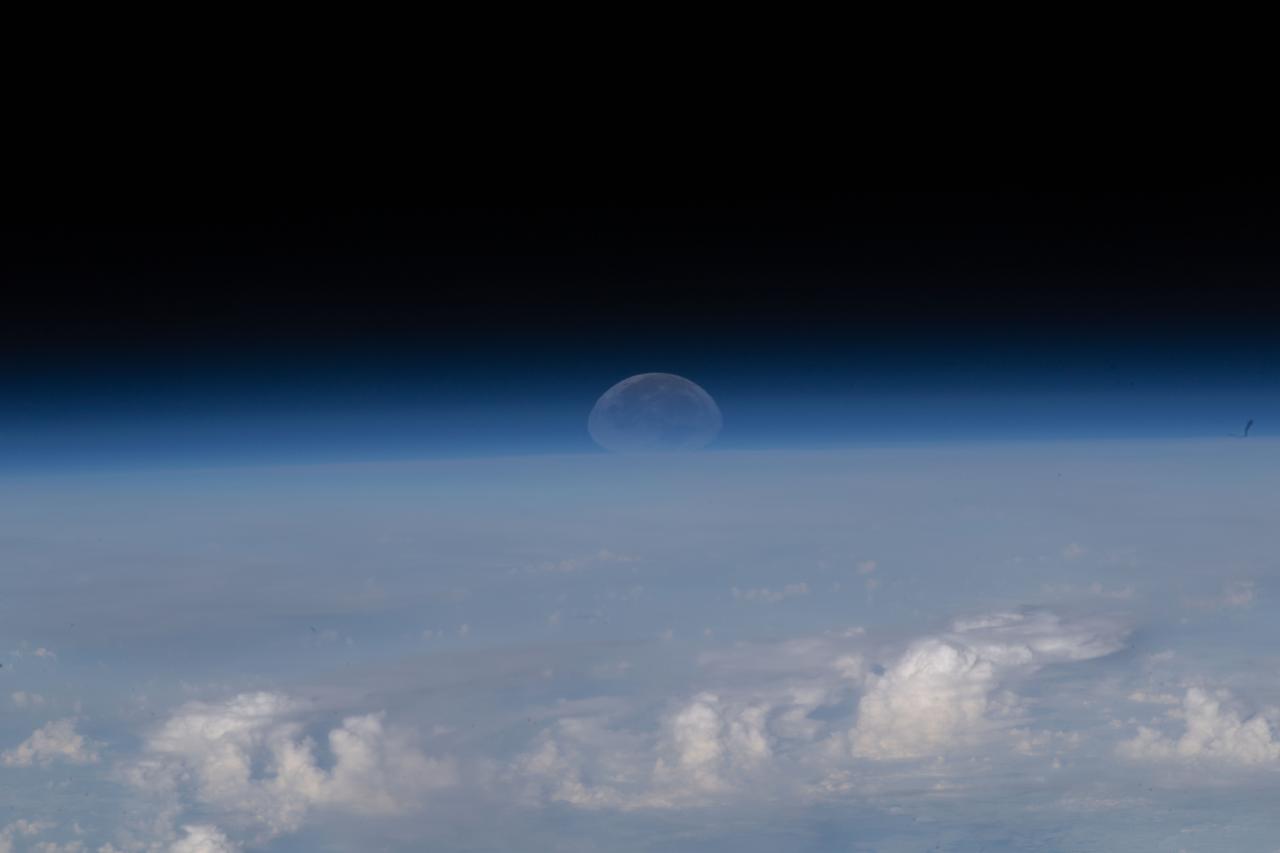 iss067e139458 (June 15, 2022) --- As the Moon sets below Earth's horizon the atmosphere refracts, or bends, its light making it appear flatter in this photograph taken from the International Space Station as it orbited 261 miles above the Himalayas near Kathmandu, the capital of Nepal.