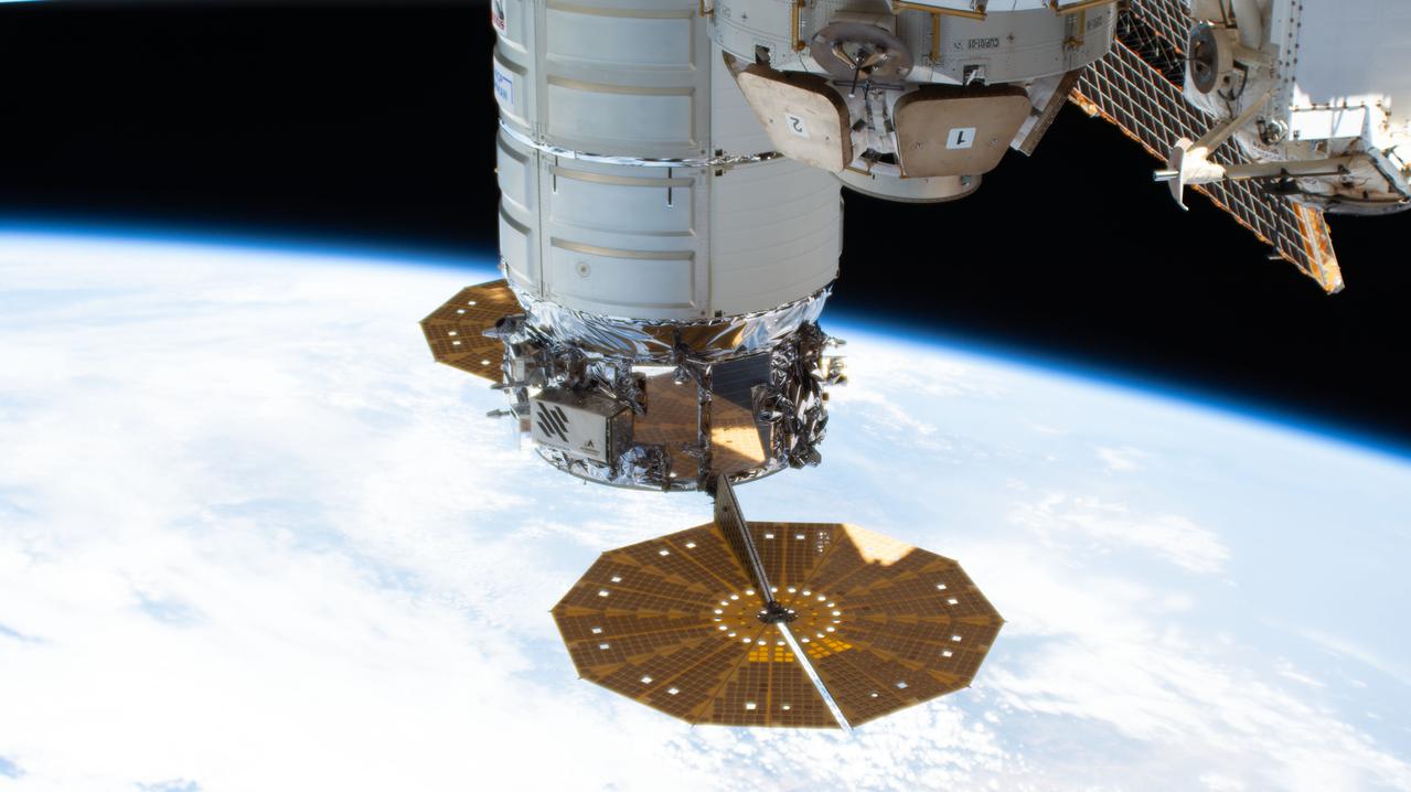 iss067e141211 (June 20, 2022) --- The Cygnus space freighter from Northrop Grumman, with its prominent cymbal-shaped solar arrays, is pictured attached to the International Space Station's Unity module as the orbiting lab flew 263 miles above the coast of Lisbon, Portugal.