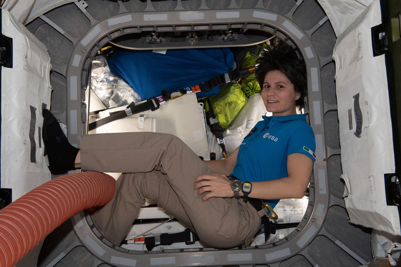 iss067e149818 (July 27, 2022) --- ESA (European Space Agency) astronaut and Expedition 67 Flight Engineer Samantha Cristoforetti is pictured inside the vestibule between the Unity module and the Cygnus space freighter finalizing cargo operations the day before the vehicle's departure from the International Space Station.