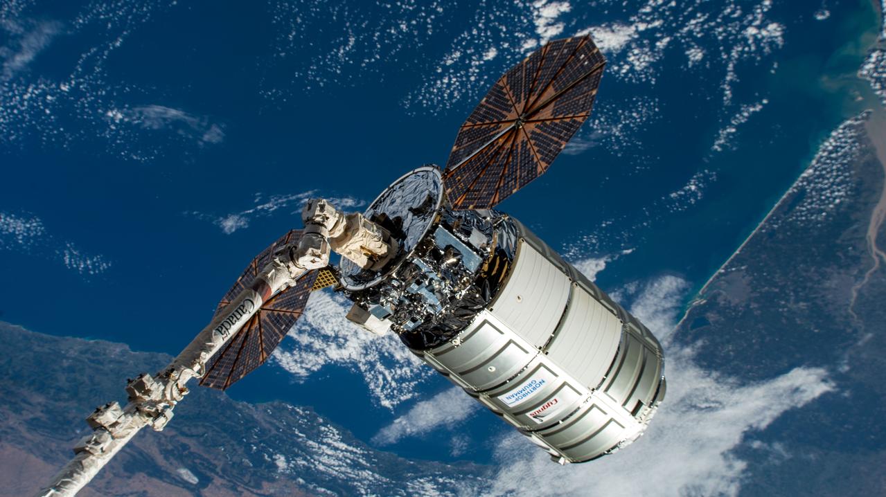 iss067e156137 (July 28, 2022) --- Northrop Grumman's Cygnus space freighter is positioned away from the International Space Station in the grips of the Canadarm2 robotic arm prior to its release ending a four-month stay attached to the orbiting lab's Unity module.