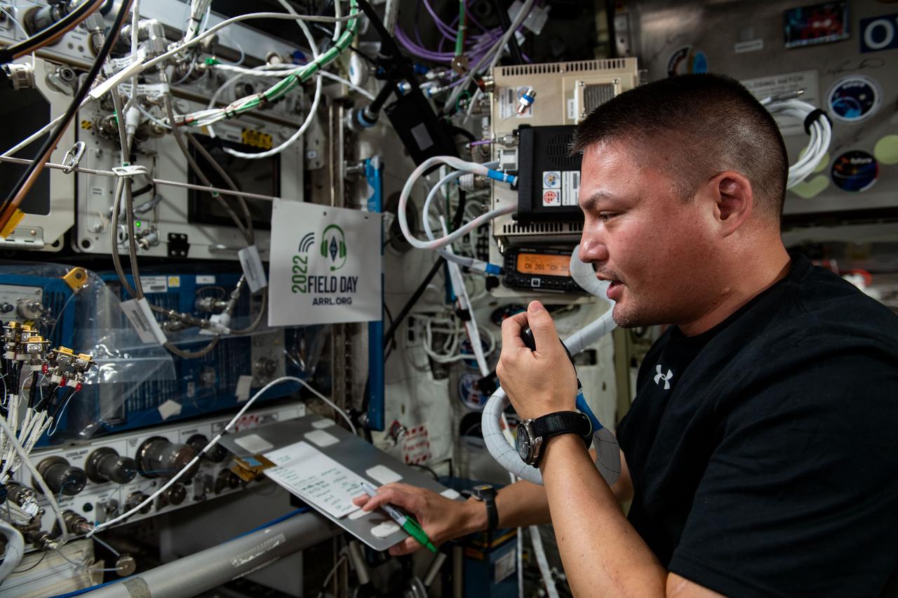 iss067e175040 (6/25/2022) --- NASA astronaut Kjell Lindgren uses the amateur radio in the Columbus module aboard the International Space Station (ISS) to participate in the annual Amateur Radio Relay League (ARRL) Field Day. Field Day allows amateur radio operators the chance to practice operating their equipment under simulated emergency conditions.