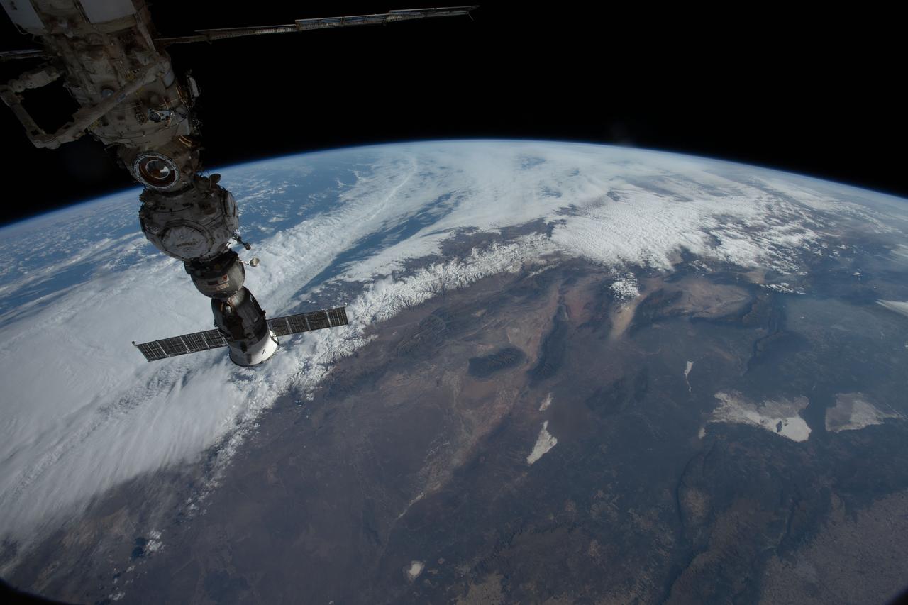 iss067e183932 (July 9, 2022) --- Central Argentina is pictured from the International Space Station as it orbited 267 miles above the South American nation. At top left (from bottom to top), is the Soyuz MS-21 crew ship docked to the Prichal docking module, which is itself attached to the Nauka multipurpose laboratory module.