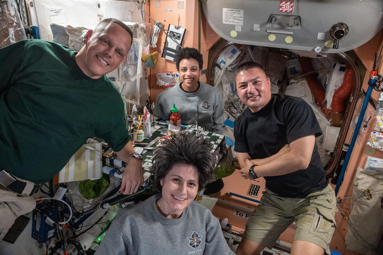 iss067e185052 (July 11, 2022) ---  (Clockwise from left) Expedition 67 Flight Engineers Bob Hines, Jessica Watkins, and Kjell Lindgren, all from NASA, and Samantha Cristofroetti from ESA (European Space Agency), pose for a portrait during dinner time in the Unity module of the International Space Station.