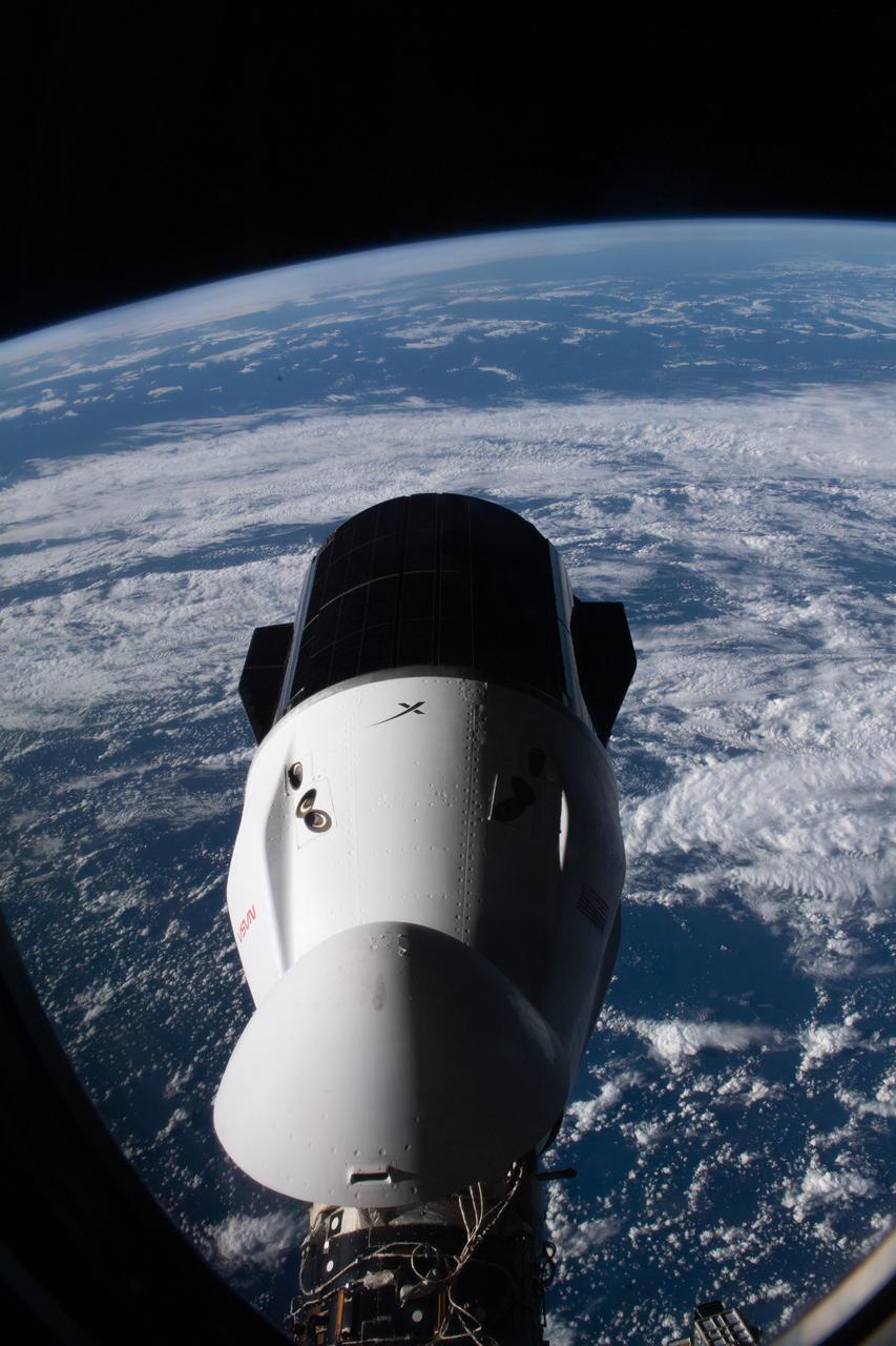 iss067e188948 (July 16, 2022) --- The SpaceX Dragon resupply ship carrying over 5,800 pounds of new science experiments and crew supplies, pictured from a window on the SpaceX Dragon Freedom crew ship, is docked to the Harmony module's forward port on the International Space Station.
