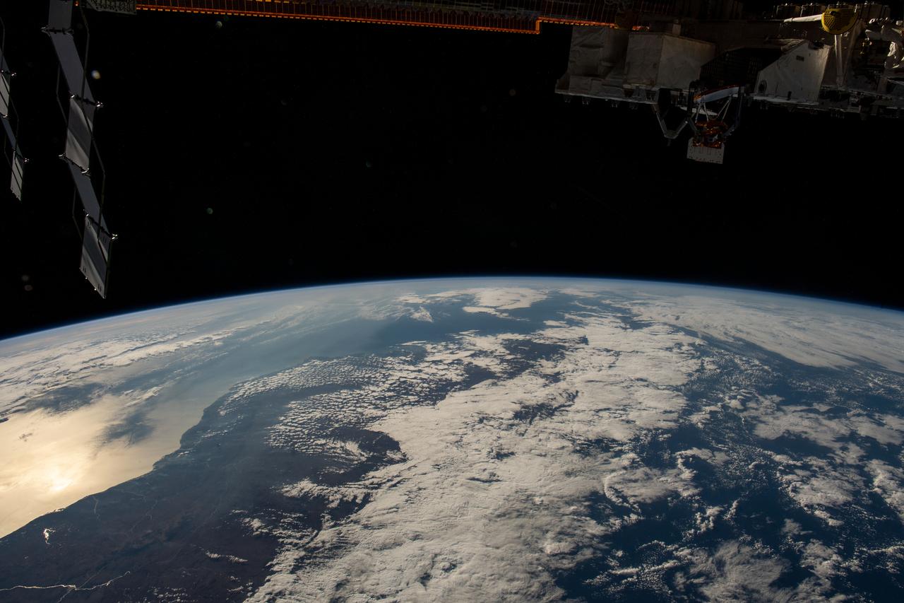 iss067e189040 (July 16, 2022) --- The sun's glint beams off the Mozambique Channel in this photograph of Madagascar's coast as the International Space Station orbited 262 miles above the Indian Ocean.