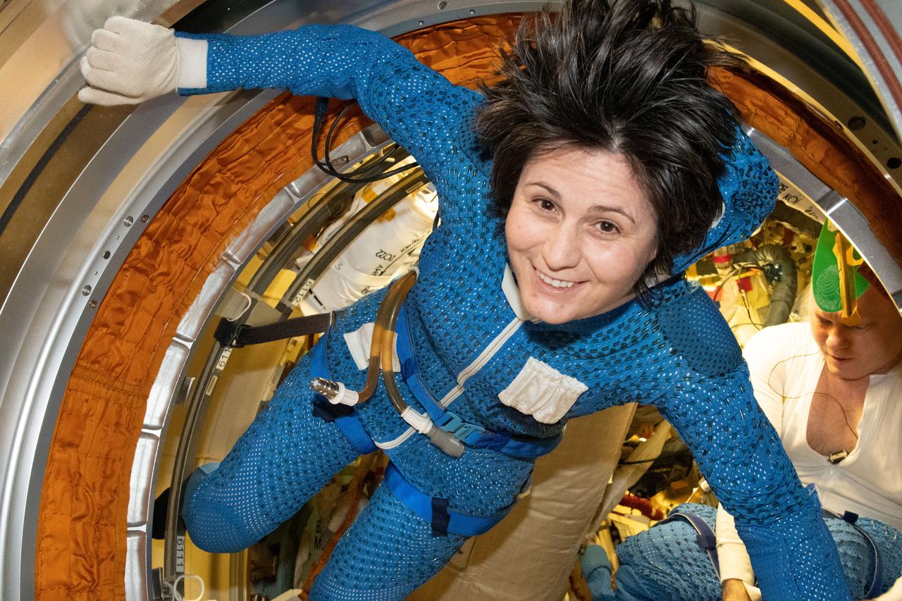 iss067e203968 (July 21, 2022) --- Expedition 67 Flight Engineer Samantha Cristoforetti of ESA (European Space Agency) is pictured inside the International Space Station's Poisk module preparing for a spacewalk. She and Expedition 67 Commander Oleg Artemyev (rear) would exit the Poisk airlock to continue the outfitting of the European robotic arm attached to Nauka during a spacewalk that lasted seven hours and five minutes.