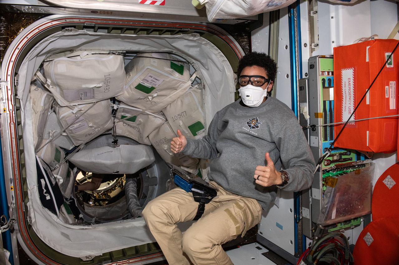 iss067e205449 (July 16, 2022) --- Expedition 67 Flight Engineer and NASA astronaut Jessica Watkins wears personal protective equipment (PPE) as a precaution before entering the SpaceX Dragon resupply ship a couple of hours after it docked to the Harmony module's forward port on the International Space Station. The PPE prevents a crew member from inadvertently coming in contact with dust and other atmospheric particles that may have dislodged inside the vehicle during its launch and ascent into Earth orbit.