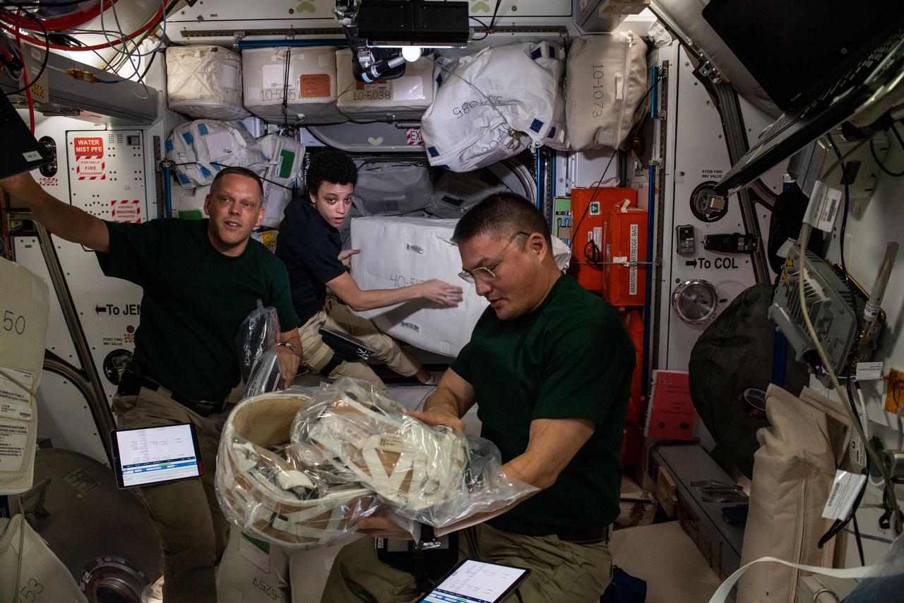 iss067e205717 (July 16, 2022) --- Expedition 67 Flight Engineers (from left) Bob Hines, Jessica Watkins, and Kjell Lindgren (all from NASA), unload cargo and time-critical science experiments a couple of hours after the SpaceX Dragon resupply ship docked to the Harmony module's forward port on the International Space Station.