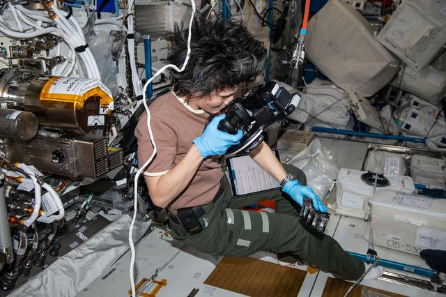 NASA image: Astronaut Samantha Cristoforetti photographs samples for a space physics experiment