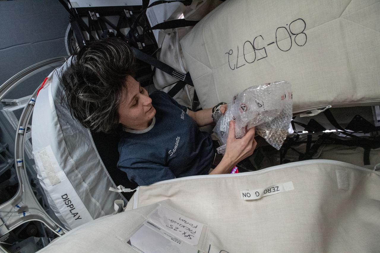 iss067e266382 (Aug. 14, 2022) --- ESA (European Space Agency) astronaut and Expedition 67 Flight Engineer Samantha Cristoforetti is pictured packing cargo inside the SpaceX Dragon resupply ship before it undocked from the International Space Station on Aug. 19, 2022.