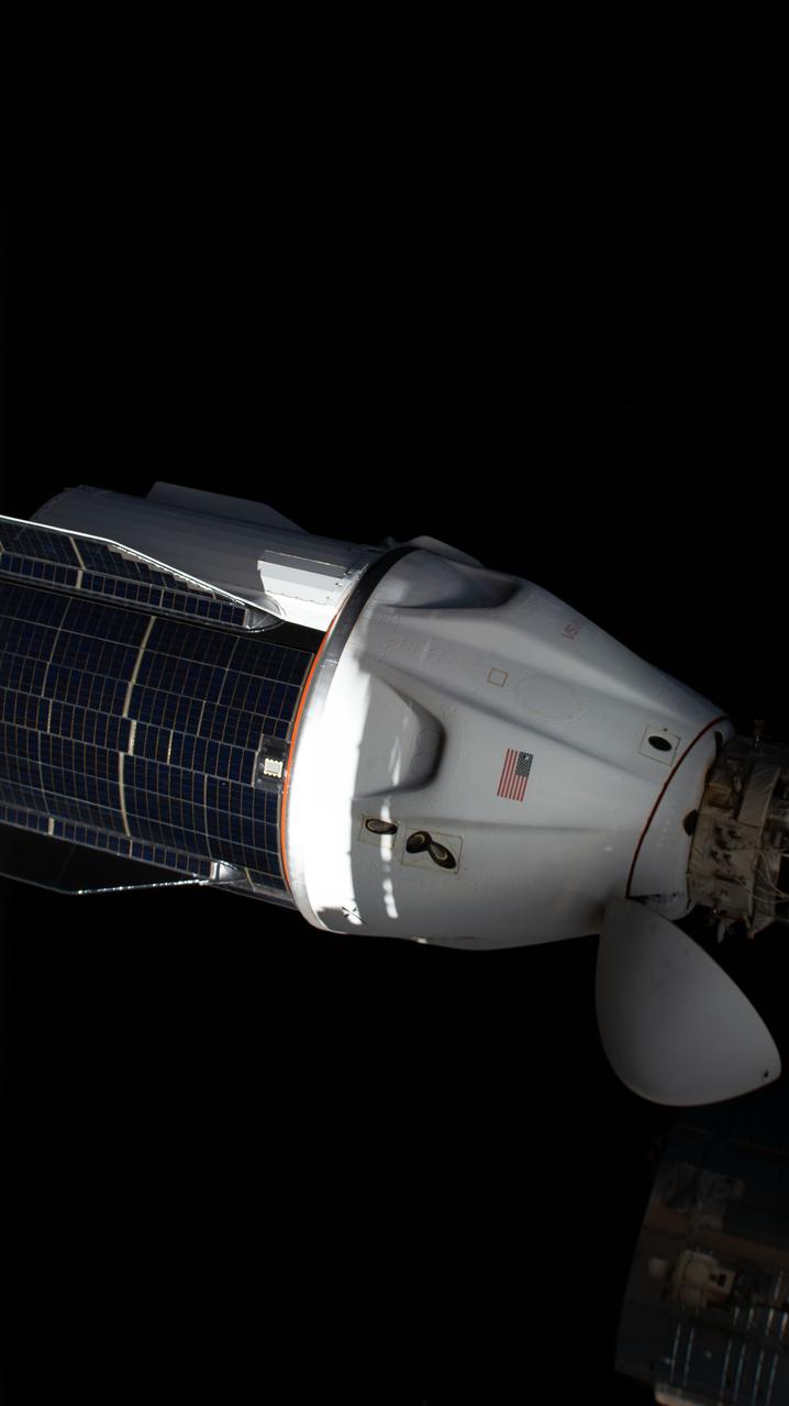 iss067e284423 (Aug. 19, 2022) --- The SpaceX Dragon resupply ship, with its solar panel-covered trunk, is pictured before undocking from the Harmony module's forward port on the International Space Station.