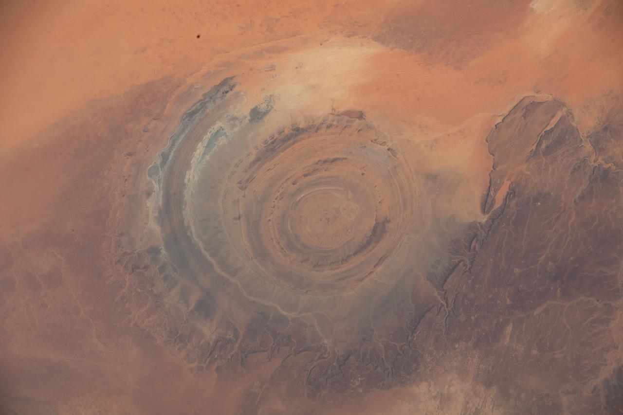 iss067e286458 (Aug. 21, 2022) --- The Richat Structure, also known as the "Eye of the Sahara," an eroded geological dome in the nation of Mauritania, is pictured from the International Space Station as it orbited 256 miles above northwestern Africa.