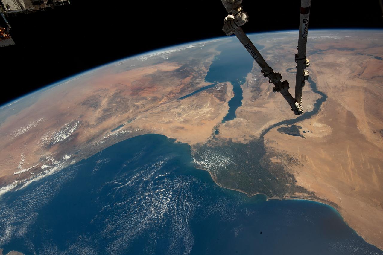 iss067e286504 (Aug. 21, 2022) --- The Canadarm2 robotic arm extends from the top right foreground, with the Nile Delta and the Red Sea, situated in the Arabian Peninsula, pictured from the International Space Station as it orbited 257 miles above the Mediterranean Sea.