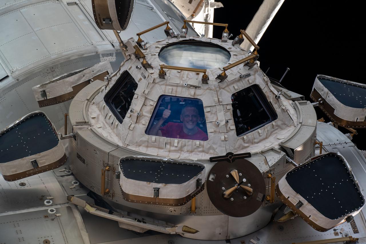 iss067e359812 (Sept. 12, 2022) --- NASA astronaut and Expedition 67 Flight Engineer Bob Hines is pictured looking out from a window on the cupola, the International Space Station's "window to the world." The astronauts use the seven-windowed cupola to monitor the arrival of spaceships at the orbiting lab and view the Earth below.