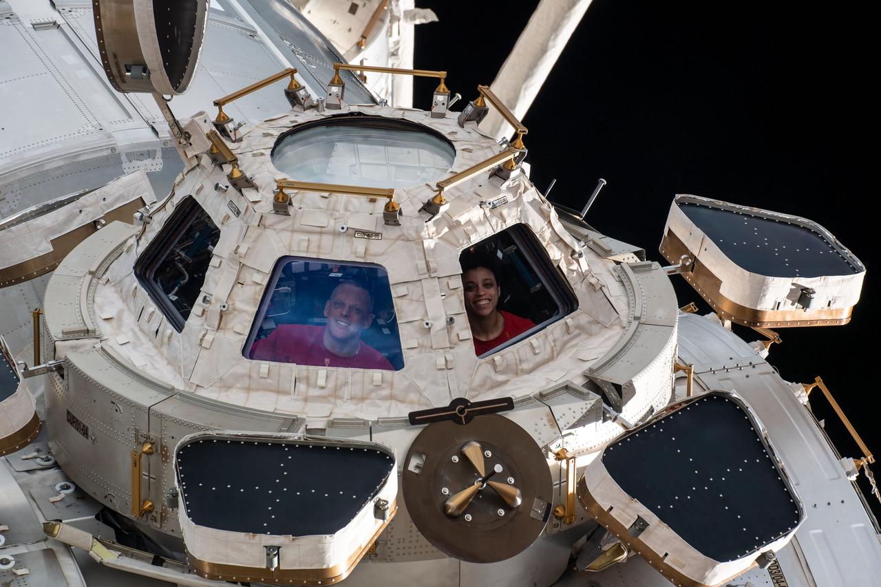 iss067e359846 (Sept. 12, 2022) --- Expedition 67 Flight Engineers Bob Hines and Jessica Watkins, both from NASA, are pictured looking out from a window on the cupola, the International Space Station's "window to the world." The astronauts use the seven-windowed cupola to monitor the arrival of spaceships at the orbiting lab and view the Earth below.