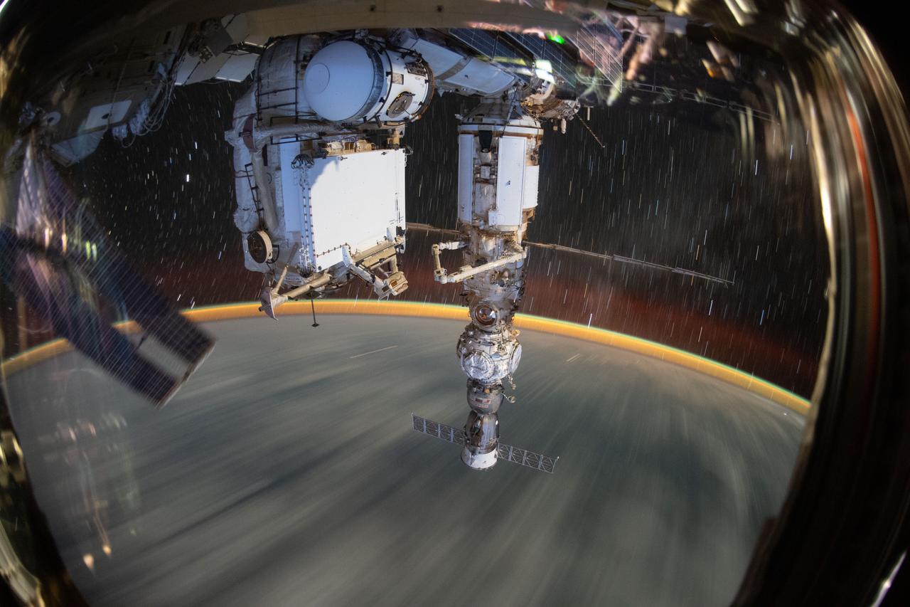 iss067e378755 (Sept. 19, 2022) --- This long-duration photograph shows the Earth 259 miles below a soaring International Space Station. In the foreground, is the Soyuz MS-21 crew ship docked to the Prichal docking module which is itself attached to the Nauka multipurpose laboratory module.