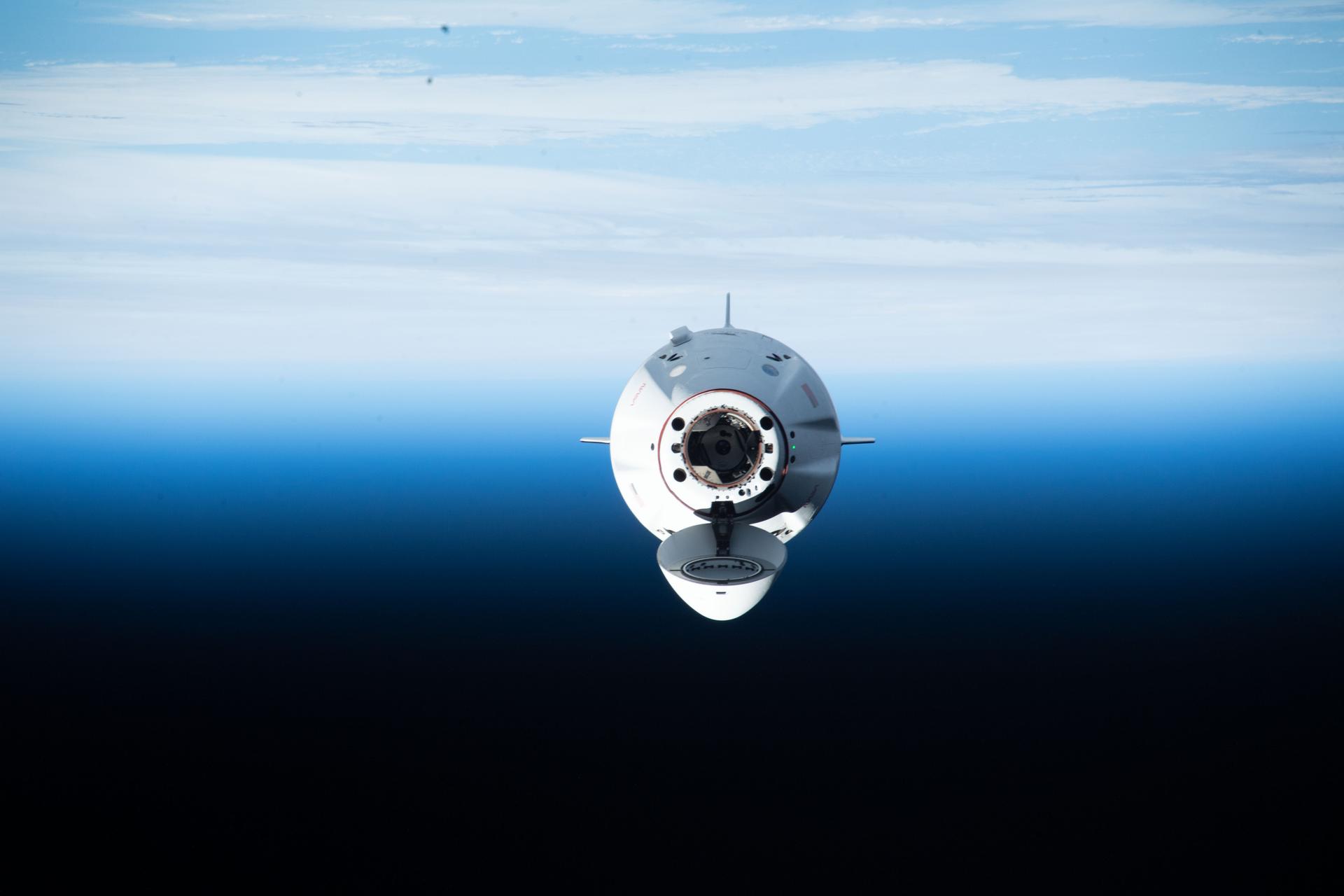 The SpaceX Dragon Endurance crew ship approaches the International Space Station as Earth's horizon is seen in the background.