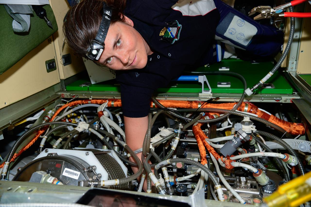 iss068e017239 (Oct. 13, 2022) --- Roscosmos cosmonaut and Expedition 68 Flight Engineer Anna Kikina works on electronics and communications maintenance inside the International Space Station's Nauka multipurpose laboratory module. Credit: Roscosmos