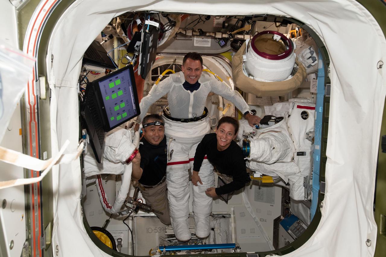 iss068e020678 (Nov. 5, 2022) --- NASA astronaut Josh Cassada (center) is pictured trying on an Extravehicular Mobility Unit (EMU), or spacesuit, with assistance from astronaut Koichi Wakata (left) of the Japan Aerospace Exploration Agency and NASA astronaut Nicole Mann (right) inside the International Space Station's Quest airlock. Credit: Josh Cassada/NASA