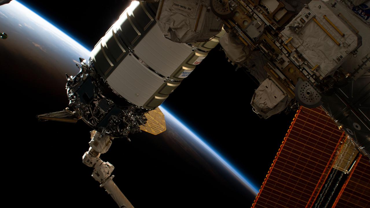 iss068e021452 (Nov. 9, 2022) --- The Northrop Grumman Cygnus space freighter is pictured in the grip of the Canadarm2 robotic arm as ground controllers remotely install the cargo craft to the International Space Station's Unity module. The space station was orbiting into a sunset 257 miles above the Indian Ocean off the coast of the African nation of Tanzania.