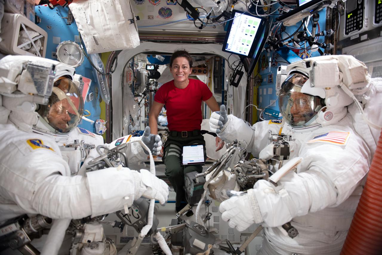 iss068e022312 (Nov. 15, 2022) --- NASA astronaut Nicole Mann (center) assists NASA astronauts Josh Cassada (left) and Frank Rubio (right), suited up in their Extravehicular Mobility Units (EMU), or spacesuits, before beginning a seven-hour and 11-minute a spacewalk to ready the orbiting lab's starboard truss structure for future rollout solar array installation work. Credit: Koichi Wakata/Japan Aerospace Exploration Agency (JAXA)
