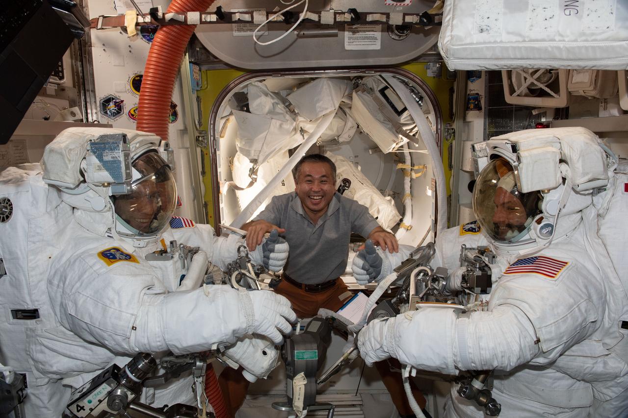 iss068e022314 (Nov. 15, 2022) --- Japan Aerospace Exploration Agency (JAXA) astronaut Koichi Wakata (center) assists NASA astronauts Frank Rubio (left) and Josh Cassada (right), suited up in their Extravehicular Mobility Units (EMU), or spacesuits, before beginning a seven-hour and 11-minute a spacewalk to ready the orbiting lab's starboard truss structure for future rollout solar array installation work. Credit: Koichi Wakata/Japan Aerospace Exploration Agency (JAXA)