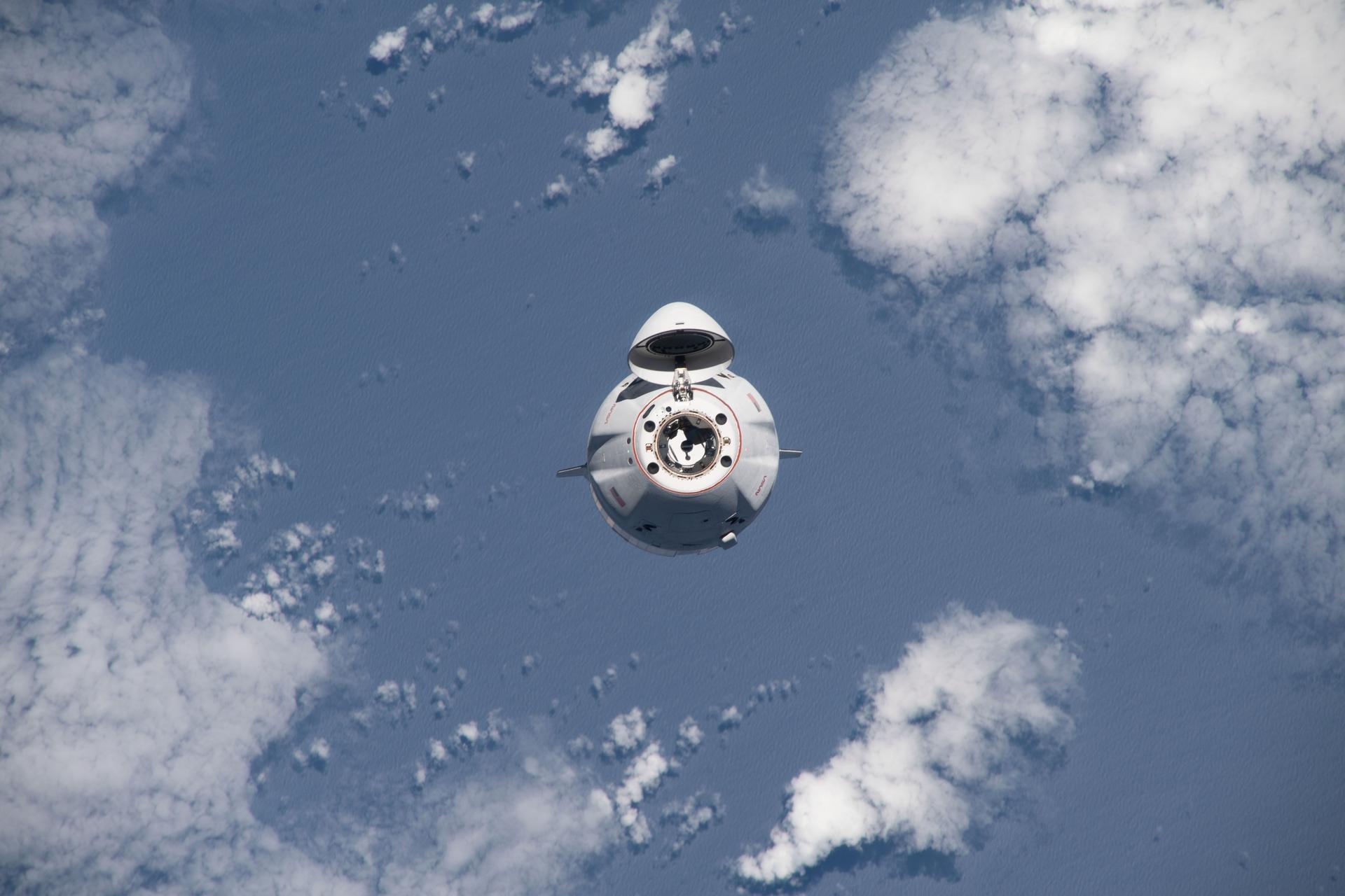 The SpaceX Dragon cargo craft, loaded with over 7,700 pounds of science, supplies, and cargo, approaches the International Space Station for a docking 264 miles above the Atlantic ocean in between South America and Africa