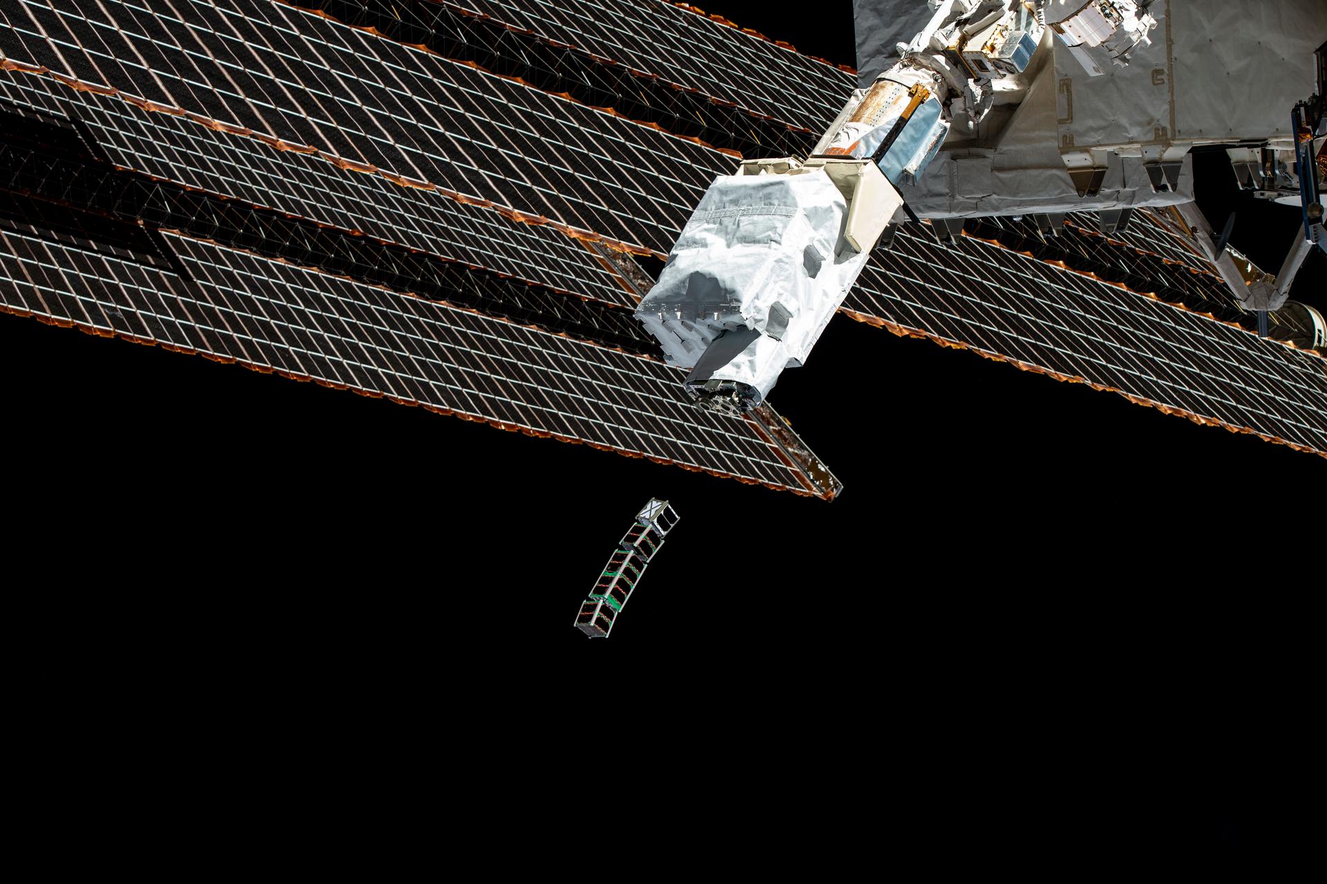 image of a cubesat being deployed from the space station