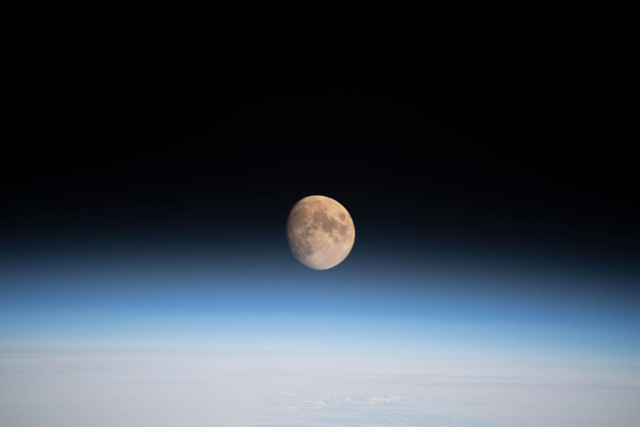 iss068e026673 (Dec. 4, 2022) --- The waxing gibbous Moon is pictured above Earth's horizon from the International Space Station as it orbited 261 miles over the northern Pacific Ocean. At the time of this photograph the Orion vehicle on the Artemis I mission was almost 24,000 miles away from the Moon and approximately 222,200 miles from Earth traveling at a speed of 3,076 miles per hour.