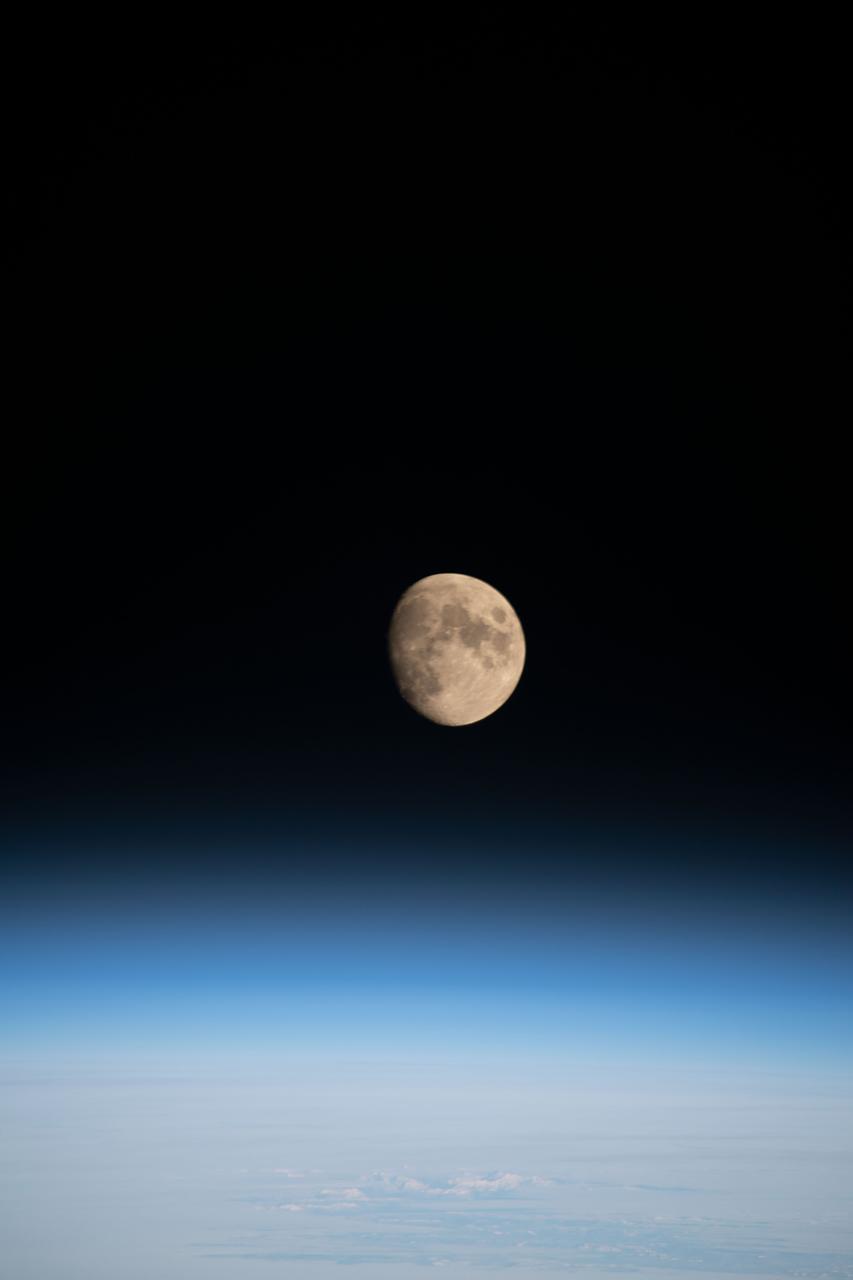 iss068e026681 (Dec. 4, 2022) --- The waxing gibbous Moon is pictured above Earth's horizon from the International Space Station as it orbited 261 miles over the northern Pacific Ocean. At the time of this photograph the Orion vehicle on the Artemis I mission was almost 24,000 miles away from the Moon and approximately 222,200 miles from Earth traveling at a speed of 3,076 miles per hour.