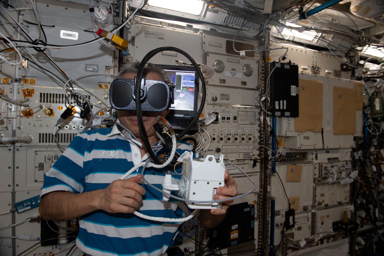 iss068e040441 (Jan. 13, 2023) --- Expedition 68 Flight Engineer Koichi Wakata of the Japan Aerospace Exploration Agency (JAXA) wears virtual reality goggles and practices for the unlikely emergency scenario of becoming untethered from the International Space Station during a spacewalk. The virtual training familiarizes astronauts with operating the jet pack attached to their Extravehicular Mobility Units, or spacesuits, to safely return to the orbiting lab in the event they become detached during a spacewalk. The jet pack is also known by its longer name Simplified Aid for EVA Rescue, or SAFER.