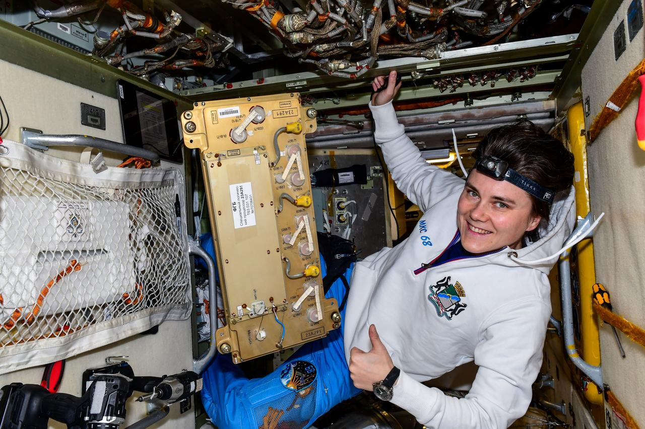 iss068e040769 (Jan. 17, 2023) --- Roscosmos cosmonaut and Expedition 68 Flight Engineer Anna Kikina removes and replaces electronics hardware inside the International Space Station's Zarya module. Credit: Roscosmos