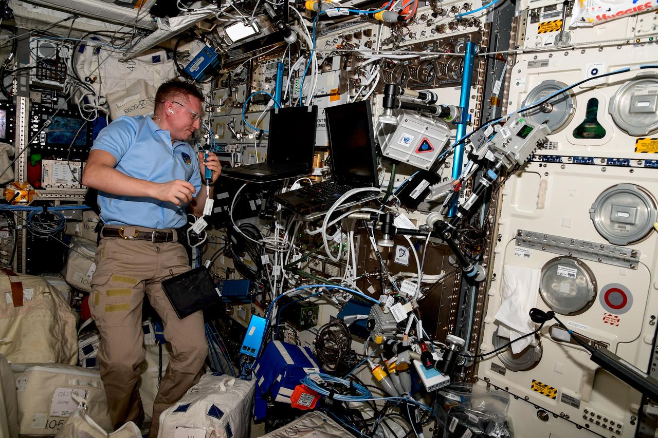 iss068e0420749 (Jan. 25, 2023) --- Roscosmos cosmonaut and Expedition 68 Commander Sergey Prokopyev connects valves and manipulates hoses to change gases from neon to argon for the Plasma Crystal experiment. The space physics study takes place inside the International Space Station's Columbus laboratory module and explores how clouds of highly charged particles, or plasma crystals, behave in microgravity.