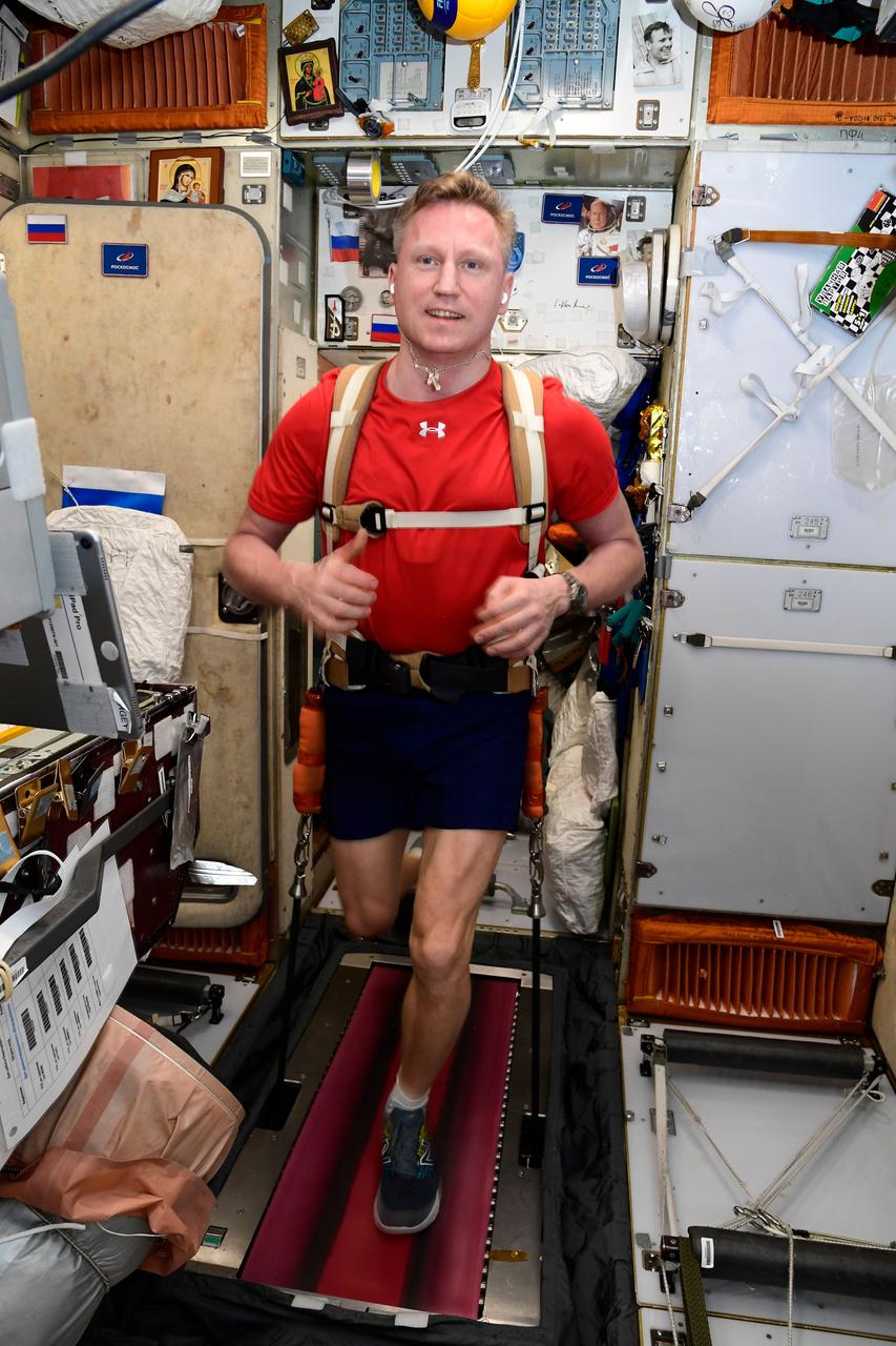 iss068e042982 (Jan. 26, 2023) --- Roscosmos cosmonaut and Expedition 68 Commander Sergey Prokopyev jogs while tethered to the treadmill inside the International Space Station's Zvezda service module. Credit: Roscosmos