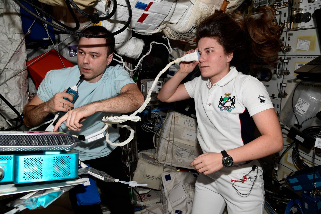 iss068e042987 (Jan. 26, 2023) --- Expedition 68 Flight Engineers Dmitri Petelin and Anna Kikina, both from Roscosmos, participate in ultrasound eye scans aboard the International Space Station to understand how living long-term in microgravity affects the human eye. The duo used the Ultrasound 2 device located in the Columbus laboratory module's Human Research Facility. Credit: Roscosmos