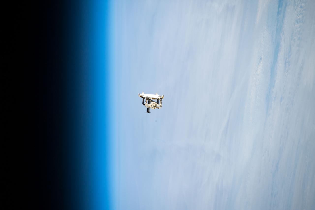 iss068e044261 (Jan. 31, 2023) --- Flight support equipment is pictured descending toward the Earth's atmosphere after being jettisoned from the grips of the Canadarm2 robotic arm. The flight hardware secured a pair of roll-out solar arrays inside SpaceX Dragon cargo ship’s trunk during its ascent to orbit and rendezvous with the International Space Station in November 2022. The jettisoned support equipment drifted safely away from the station and will eventually harmlessly burn up in the atmosphere with no chance for recontacting the space station.