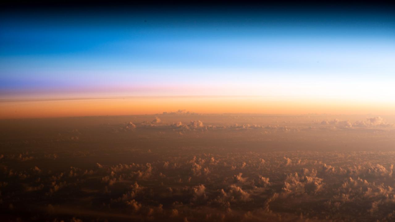 iss068e051172 (Feb. 10, 2023) --- The soft hues of an orbital sunrise begins revealing the cloud tops above the Pacific Ocean northeast of New Zealand as the International Space Station orbited 260 miles above.
