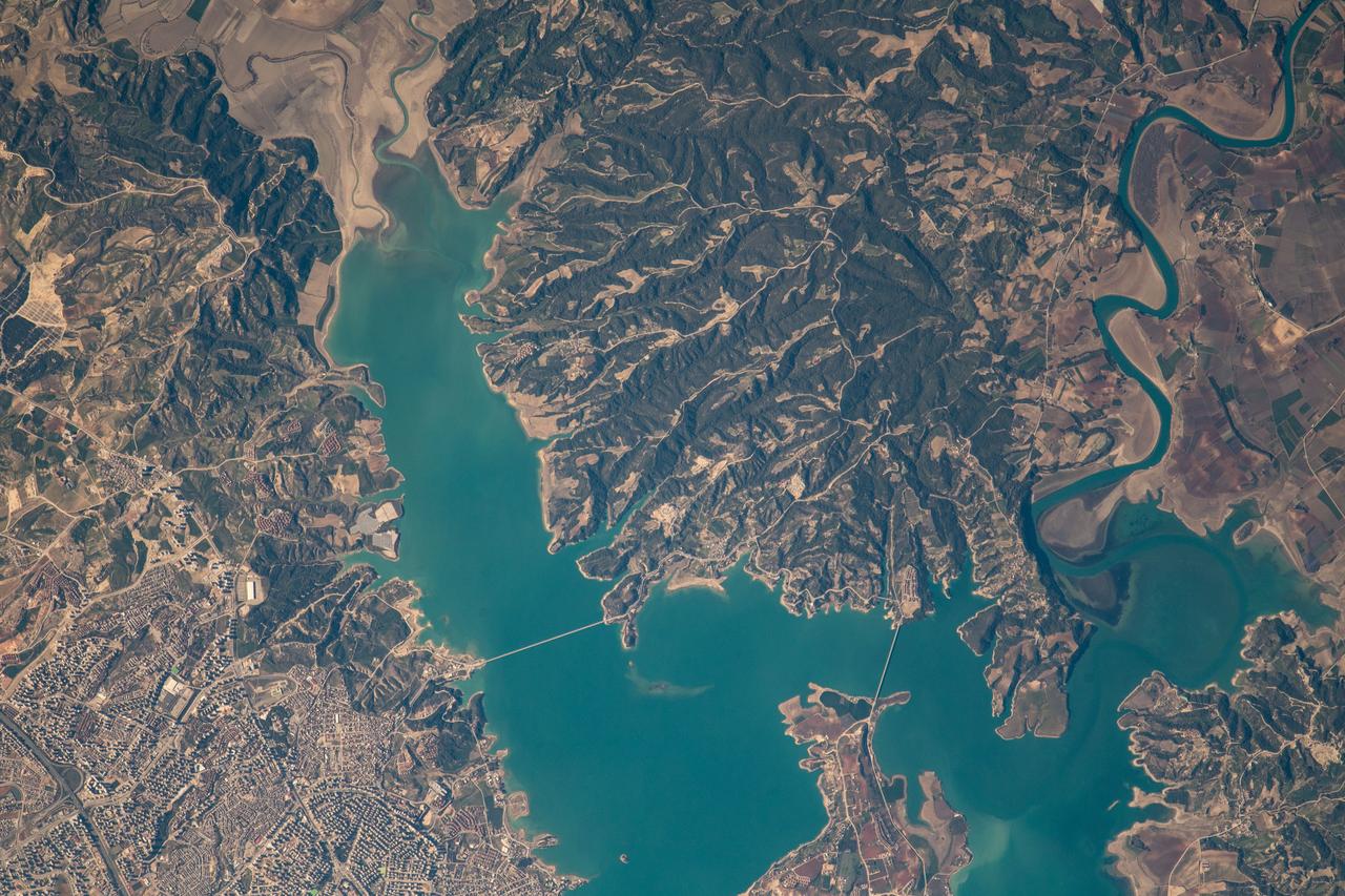 iss068e053748 (Feb. 14, 2023) --- At lower left, the city of Adana, Turkey, rests on the banks of the Seyhan Dam Lake in this photograph from the International Space Station as it orbited 264 miles above. Prominent at lower center, is the Çatalan Bridge.