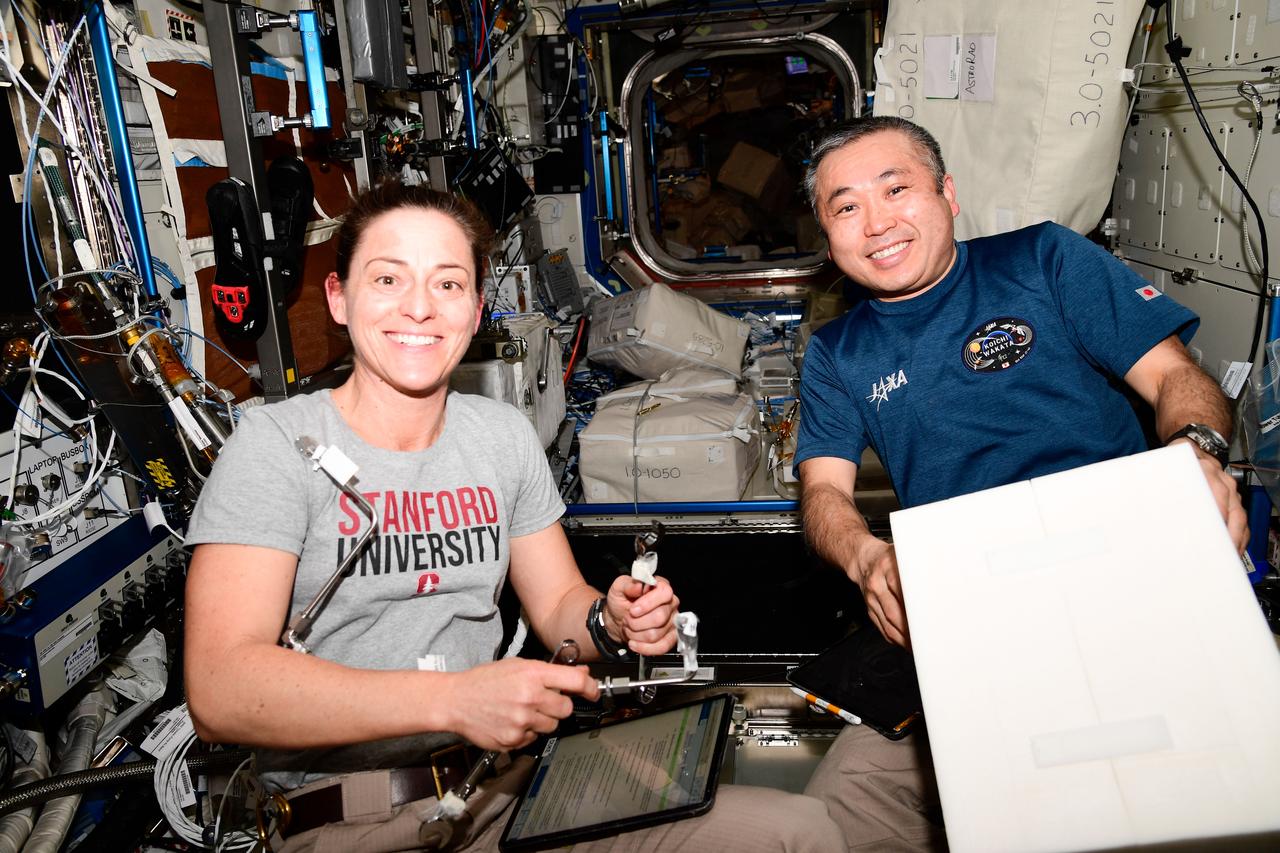iss068e054592 (Feb. 13, 2023) --- Expedition 68 Flight Engineers Nicole Mann of NASA and Koichi Wakata of JAXA (Japan Aerospace Exploration Agency) work on life support maintenance inside the International Space Station's Destiny laboratory module.