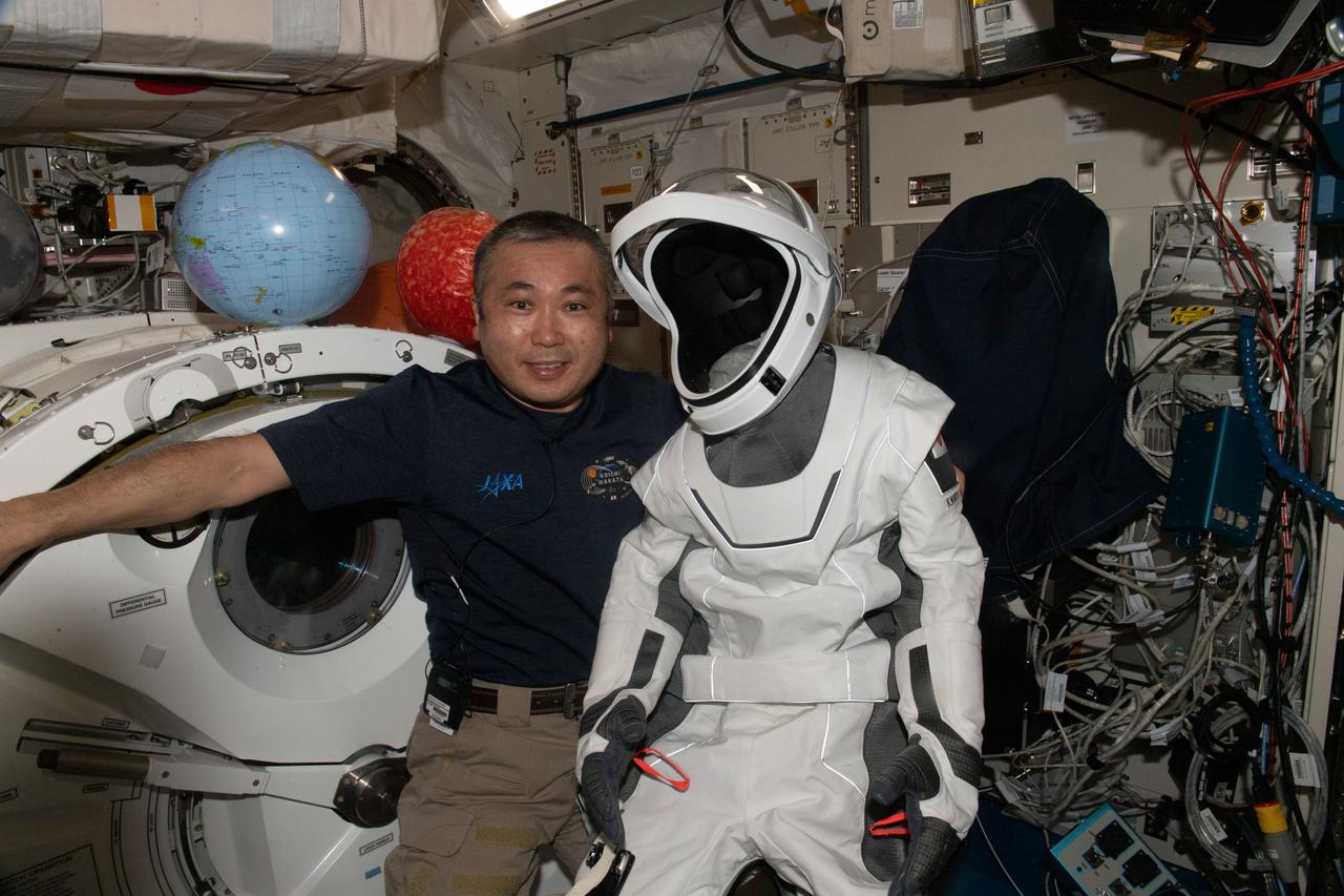 iss068e058259 (Feb. 26, 2023) --- Expedition 68 Flight Engineer Koichi Wakata of JAXA (Japan Aerospace Exploration Agency) shows off his SpaceX pressure suit he wore aboard the Crew Dragon Endurance spaceship when he launched to the International Space Station on Oct. 5 from the Kennedy Space Center in Florida.
