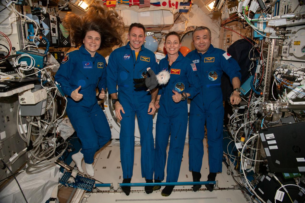 iss068e065016_alt (March 1, 2023) --- From left, are Expedition 68 Flight Engineers Anna Kikina of Roscosmos, Josh Cassada and Nicole Mann from NASA, and Koichi Wakata of JAXA (Japan Aerospace Exploration Agency) posing for a fun portrait inside the International Space Station's Kibo laboratory module.