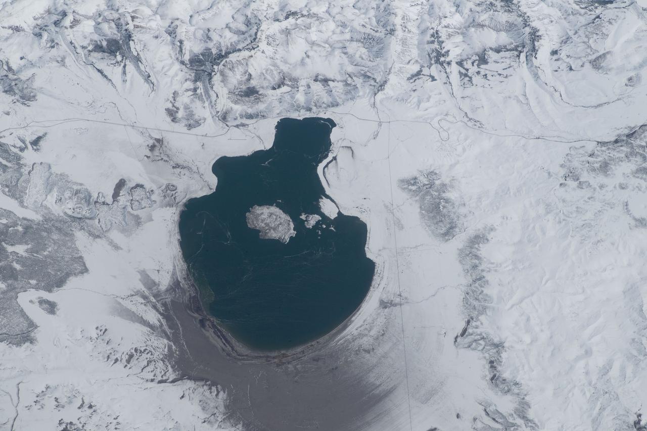 iss069e000859 (April 4, 2023) --- A snow-surrounded Mono Lake in Mono County in California was pictured by NASA astronaut and Expedition 69 Flight Engineer Woody Hoburg from the International Space Station as it orbited 262 miles above.
