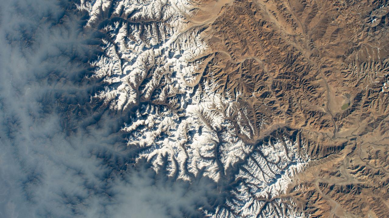 iss069e003192 (April 13, 2023) --- Clouds gather on Nepal's sub-tropical side of the Himalayas with Mount Everest at the center of this photograph taken by an external high definition camera on the International Space Station as it orbited 263 miles above the Indian subcontinent.