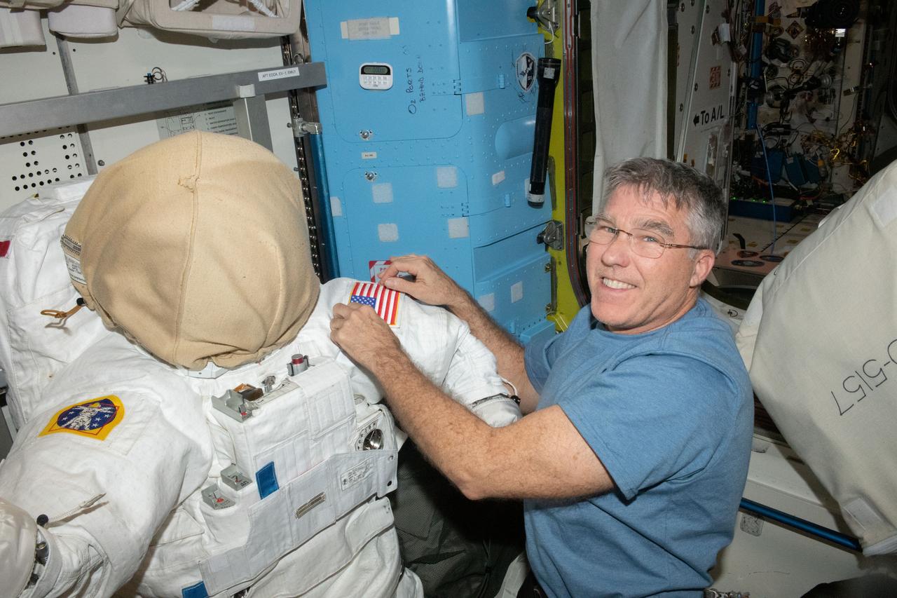 iss069e003944 (April 17, 2023) --- NASA astronaut and Expedition 69 Flight Engineer Stephen Bowen prepares an Extravehicular Mobility Unit, or spacesuit, inside the International Space Station's Quest airlock for an upcoming spacewalk.