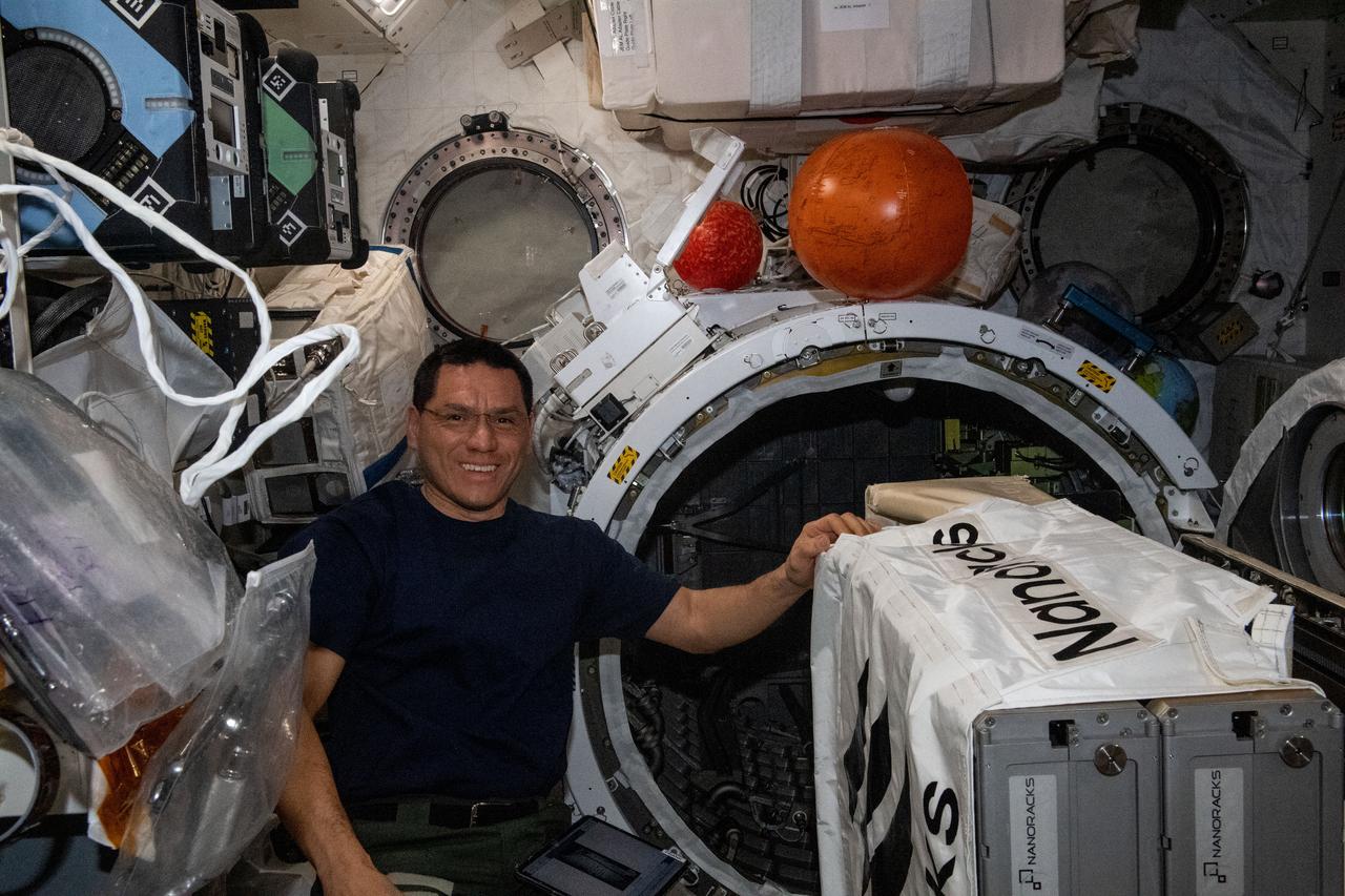 iss069e004397 (April 20, 2023) --- NASA astronaut and Expedition 69 Flight Engineer Frank Rubio works to install the NanoRacks CubeSat Deployer inside the Kibo laboratory module's airlock. After the airlock is depressurized, the Japanese robotic arm grapples the deployer and places it outside in the vacuum of microgravity pointing it away from the International Space Station. CubeSats from private, governmental, and academic organizations are then deployed into Earth orbit for a variety of research objectives.