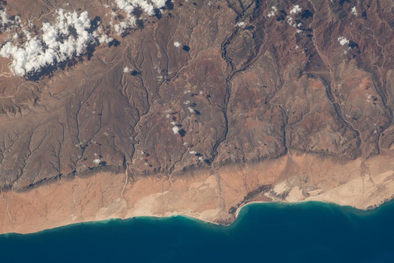 iss069e004768 (April 20, 2023) --- The southern coast of Yemeni's island of Socotra in the Arabian Sea was pictured by NASA astronaut and Expedition 69 Flight Engineer Woody Hoburg as the International Space Station orbited 257 miles above.